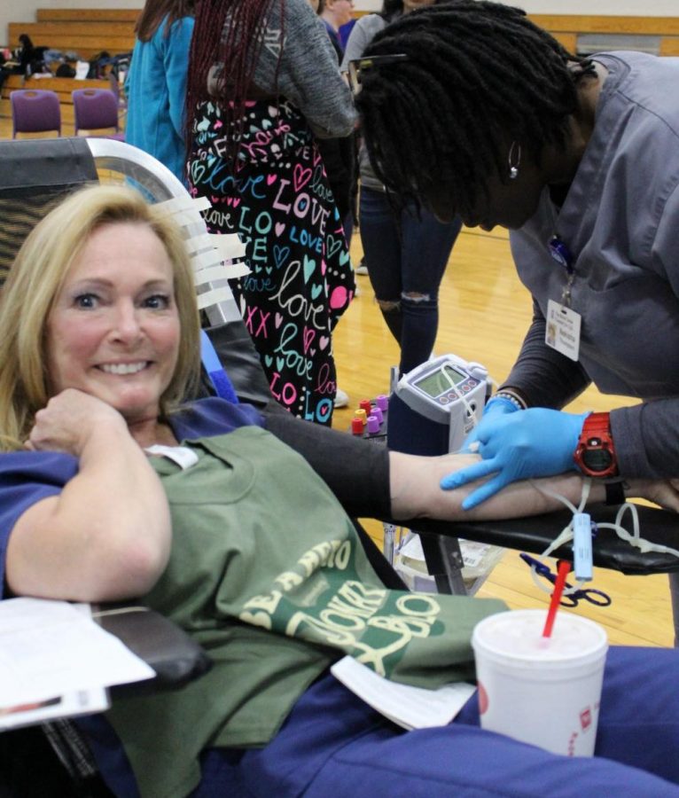 During the spring blood drive, health science teacher Katrina King donates to save lives and to set an example for her students and HOSA club members. 