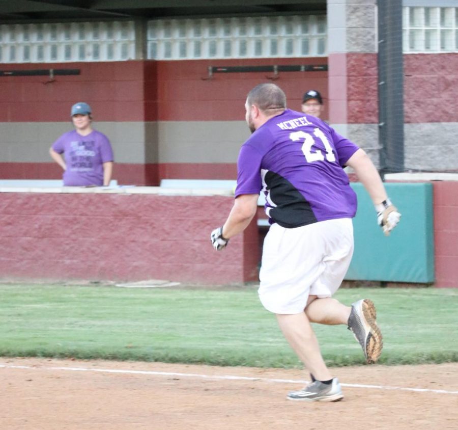 RUNNING TO FIRST. After a successful hit, AP Roger McNeel helps the WHS Scantrons secure a win in the 2018 tournament. “I enjoy playing sports and building relationships with coworkers,” McNeel said. “I played baseball in high school, and it allowed me to be confident in my ability to contribute to the team.”