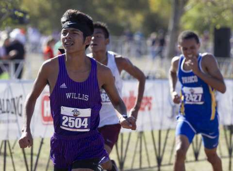 FINISHING STRONG. Giving it his all at Old Settlers Park in Round Rock at the UIL State Cross Country Meet, senior Carlos Barcenas works for a strong finish.  He broke his PR at the meet and finished in the top 20. When I run, I focus on the person in front of me, rather than the time, he said