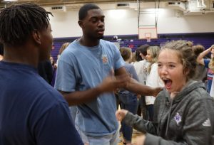 During a get-to-know-you activity at a FCA meeting, freshman Lucy Smith laughs at senior JaCoby McCoys response. When I shook his hand, he unexpectedly hugged me, Smith said. It took me by surprise.
