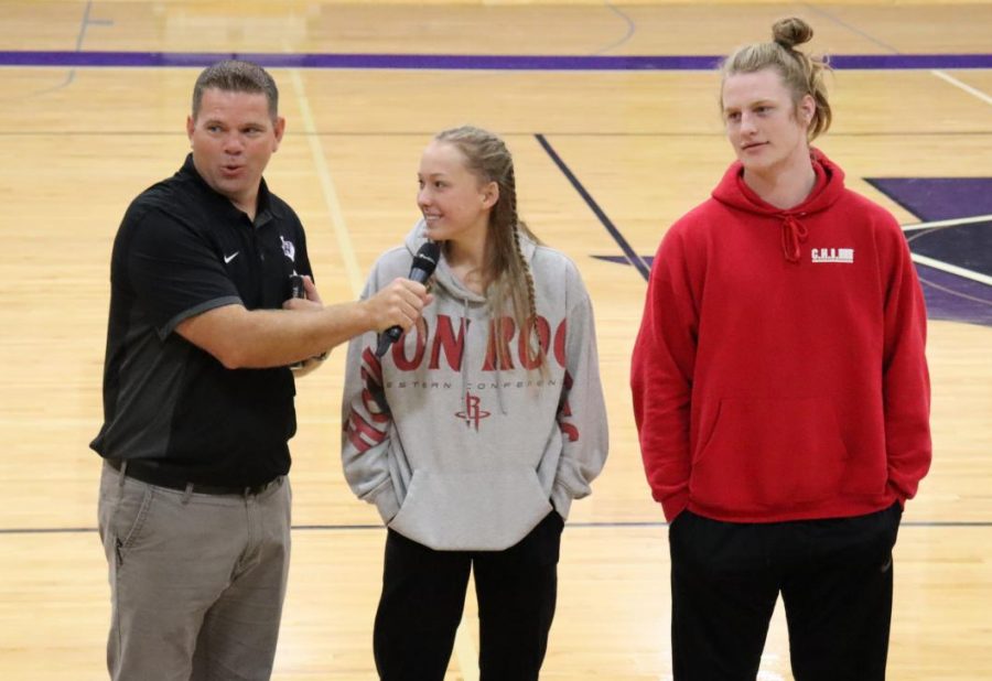 FAITH. Introducing the activity for FCA, Coach Keith Carey talks to juniors Bella Cantera and Andy Parker in front of the club. FCA is a place where kids can talk and learn about God, Parker said. It is pretty cool to have that at school.