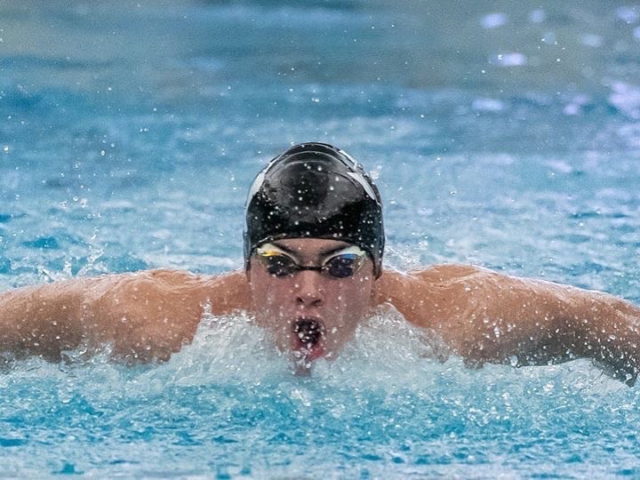Swimming the butterfly, junior Zach Clark competes against New Caney and Porter at the teams first official meet of the season last year. Clark and other members of the Aquakats, will face Oak Ridge tonight at the CISD Natatorium. 