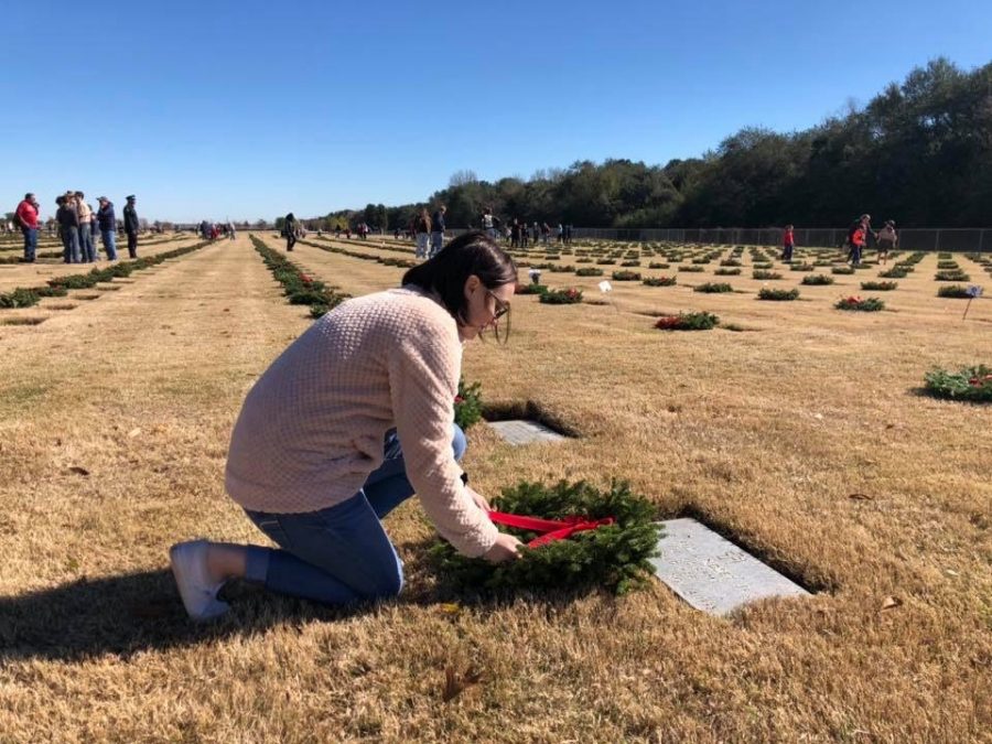 Former cadet laying wreath at gravestone. AFJROTC will be returning this year to take part in wreath laying. 