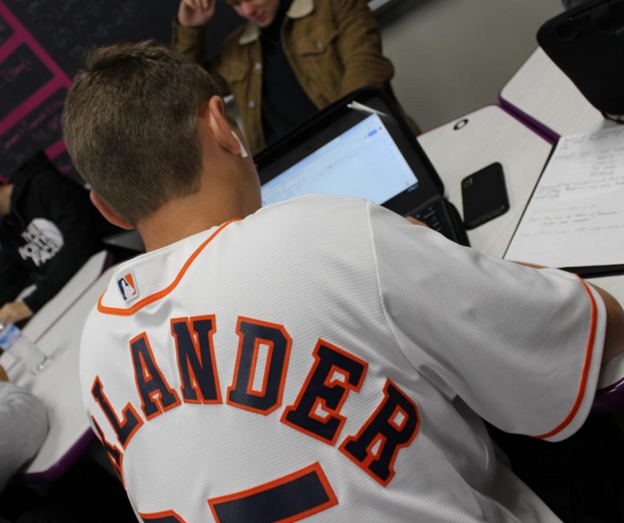 Sporting his Justin Verlander jersey, junior Heath Truett works in English class. In support of the team in the World Series, students, staff members and administration wore Astros shirts and jerseys during the play-offs and World Series. 