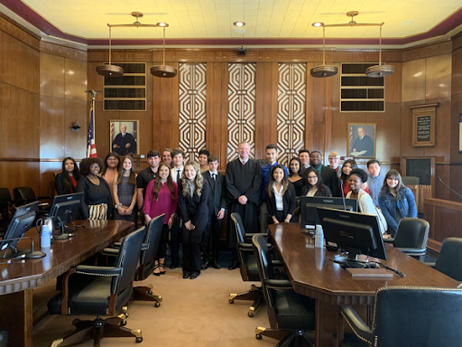 Members of the Justice League and sponsor Jessica Edwards toured a federal courthouse in Galveston. Pictured is Judge Jeff Brown with the group. 