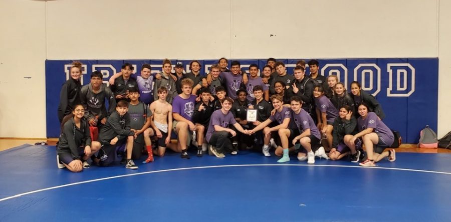 CHAMPIONS.+Celebrating+their+first+place+win+in+the+Friendswood+meet%2C+members+of+the+wrestling+team+take+a+team+pic.+The+boys+won+first+and+the+girls+earned+a+third+place+finish.+
