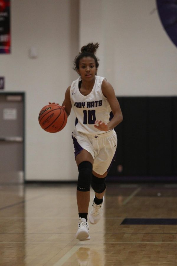 LOOKING FOR TWO. Moving down the court in a game last season against Tomball, senior Jasmine Kelly dribbles the ball. Kelly and all the seniors on the team are leading the LadyKats into district play tonight against New Caney. 