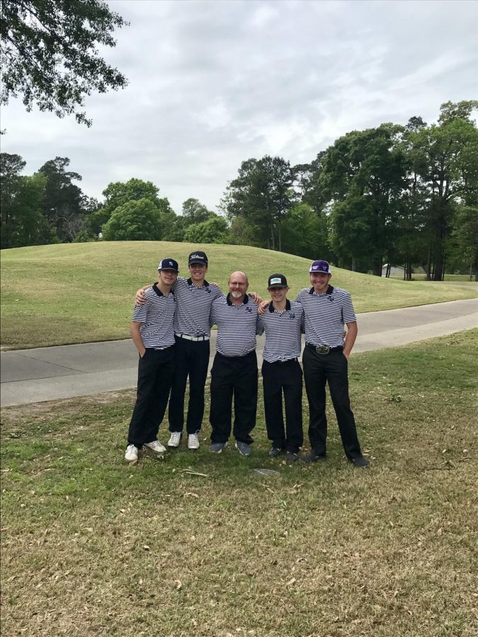 Coach Les Peacock (center) stands with members of his 2019 golf team. Peacock is currently fighting cancer and is receiving support from students and community members. 
