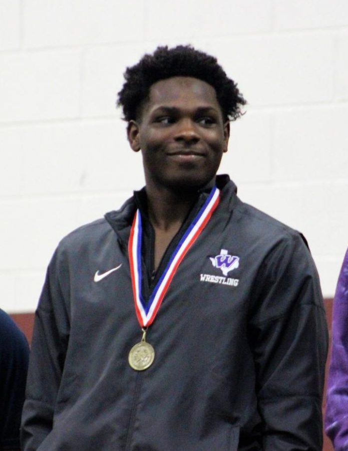 GOING FOR THE GOLD. At the top of the medal platform at district, senior Josh King celebrates a championship. King finished 4th in the state on Saturday at the state meet at the Barry Center in Cypress. "I’m the only one from my team that placed in state this year, so it felt special,” King said.  Four other Wildkats qualified for the state tournament. 