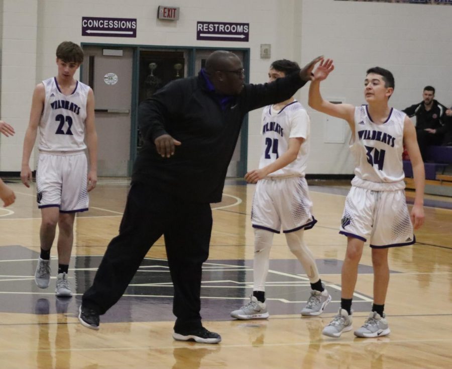 THE GREATEST. Coach Cordell Carter high-fives freshman Diego Rice in the game against Tomball. The team loved their time with Coach Carter. He will always be the GOAT, Rice said. 