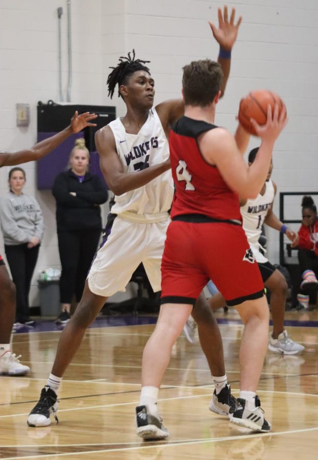 Playing defense against a Tomball player, junior JaLen Moore tries to block the ball. Moore and the rest of the Wildkats will play Katy  Paetow tonight at Spring High School.