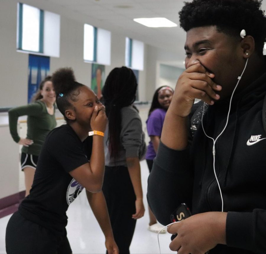 ALL LAUGHS. Taking a break from step practice freshman Rheagan Bishop and junior Keenan Rucker share a laugh. "We are the Culture  Club because we celebrate all cultures," Bishop said.  