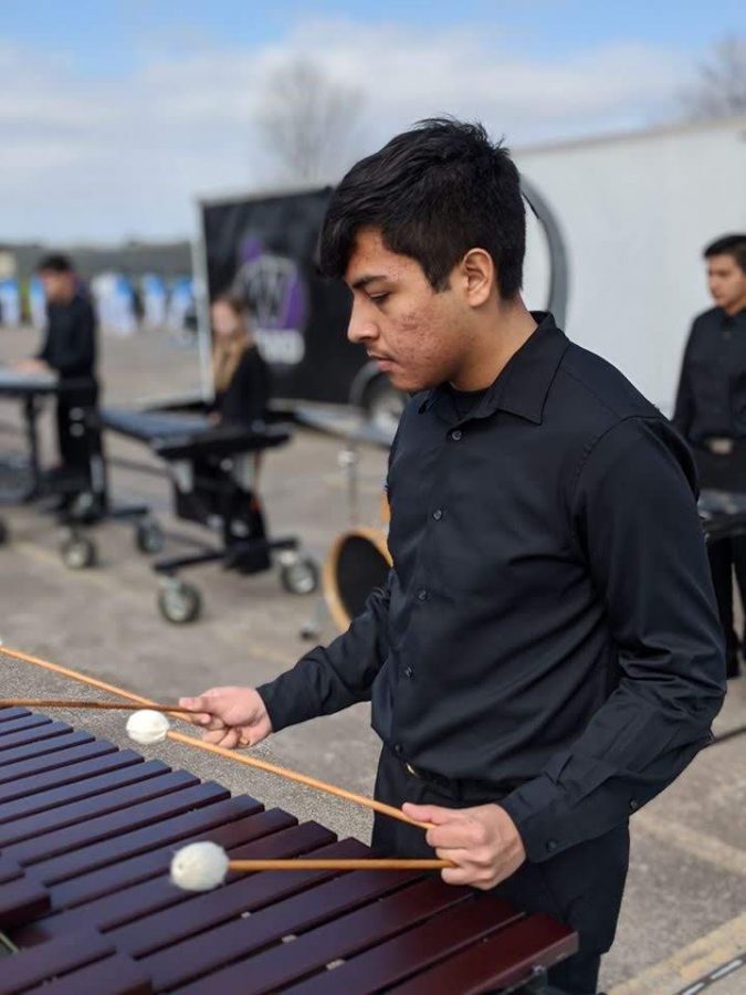 Member of the newly formed indoor percussion competition team warm up for a recent competition. This is the first year the band has competed in indoor percussion competitions.