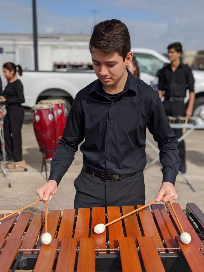 Member of the newly formed indoor percussion competition team warm up for a recent competition. This is the first year the band has competed in indoor percussion competitions.