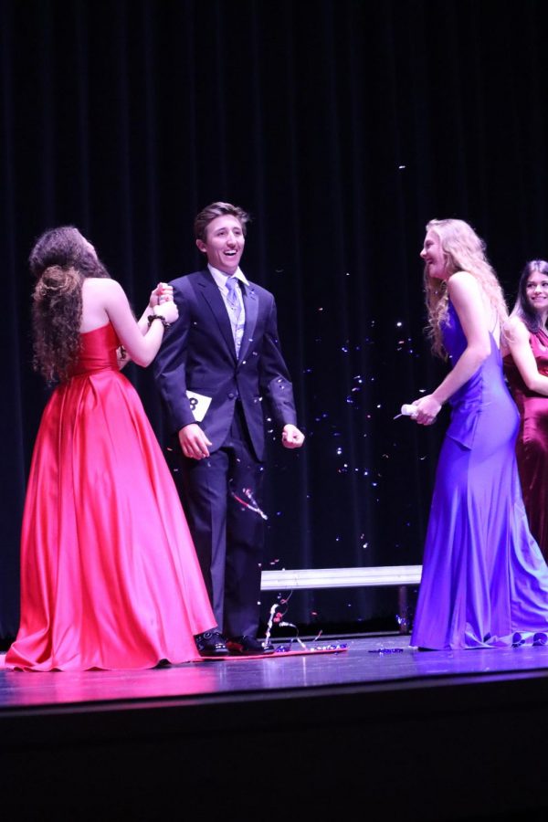 Confetti Reigns. Before finding out he was one of the top five finalists for Mr. Wildkat, senior Reed Hildenbrant struts down the runway with fellow seniors Delaney Jackson and Allison Aitken. 