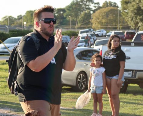 Assistant Band Director Andrew Hicks marches with the band during the homecoming parade. Hicks was recently named the head band director at Burnet High School. 