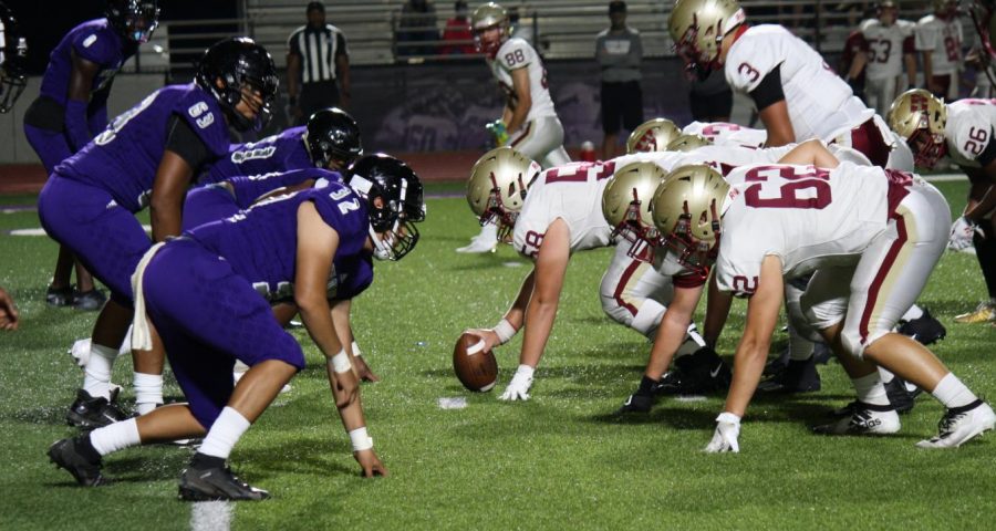 BACK UNDER THE FRIDAY NIGHT LIGHTS. Members of the Wildkat defense line up against Cy Falls in the scrimmage on September 18th. It was the first time the team played under the lights of Berton A. Yates Stadium this year. 