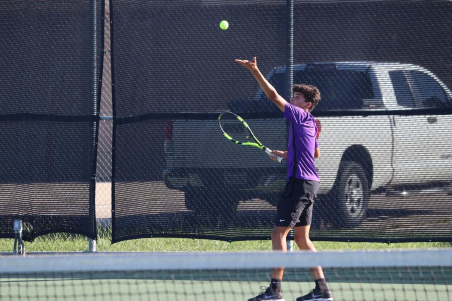SERVE IT UP. Junior Ryan Glasgow serves the ball. He played a tough match against Grand Oaks.