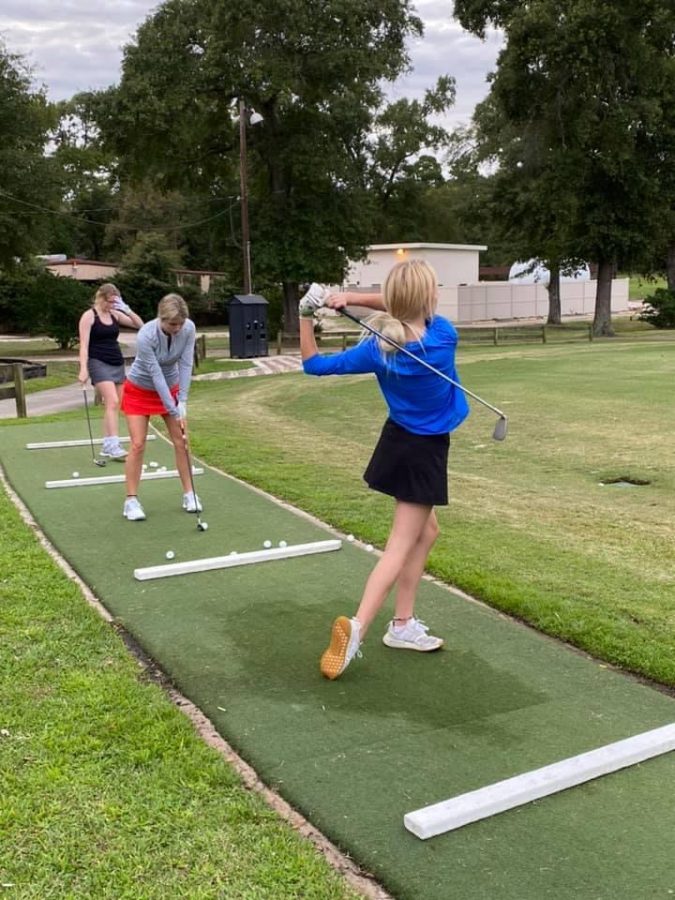 TRYING+SOMETHING+NEW.+Members+of+the+girls+golf+team+practice+at+Panorama+after+school.+They+will+have+their+first+tournament+of+the+season+there+today.+