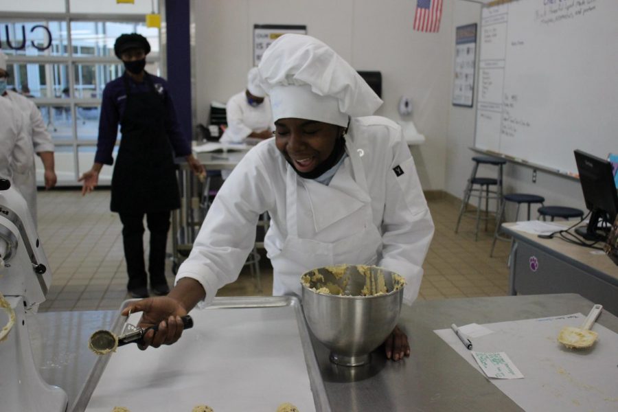 YUM. Junior Fantasia Lawrence scoops cookies onto the sheet in an advanced cullinary class. 