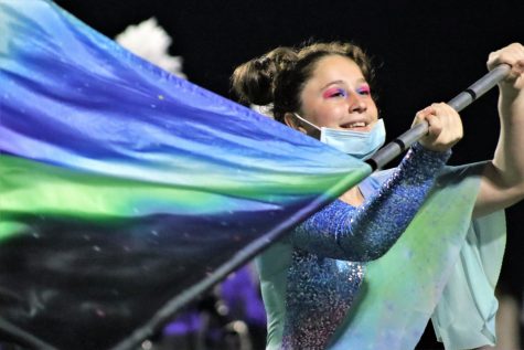 READY FOR COMPETITION.  Practicing the drill at the hoco game, junior Karen Dio smiles during the show. 