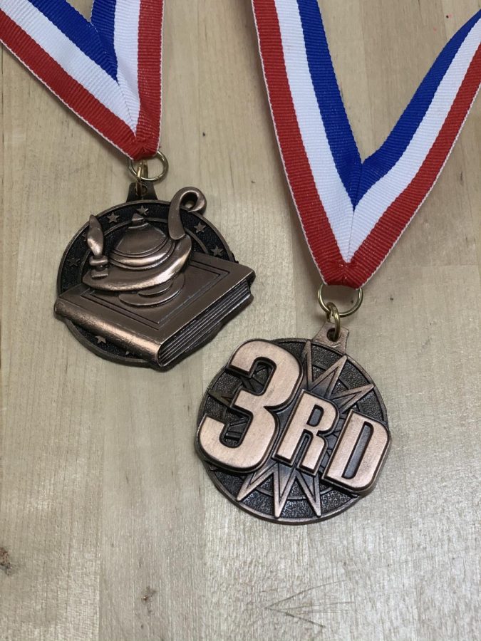 SHOW ME THE BLING. Wilkdat journalist medaled at the Rough Riders Invitational. 