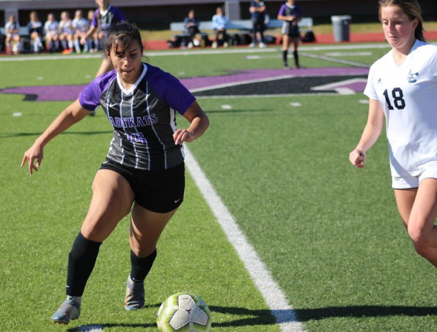 KAT CUP COMPETITION. Moving the ball, senior Alysha Martinez faces a Lake Creek player during the Kat Cup at Berton A Yates Stadium. The Kat Cup was a three day tournament the team hosts every year before district play begins, 