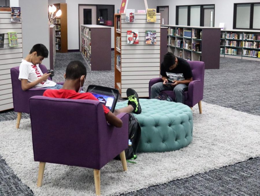 IN OPERATION. Students work while relaxing in the newly furnished area. After the new carpet was installed, the library furniture was rearranged to be the most useful and appealing to students. 