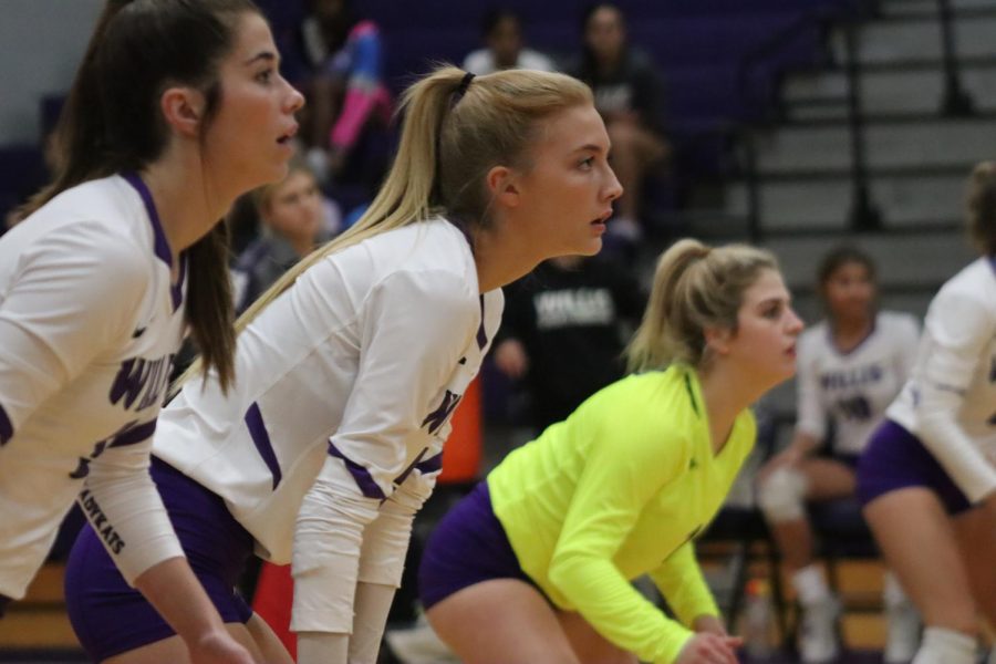 READY FOR ACTION. Waiting for the serve, seniors Reece Edmiston and Taylor Thomas with junior Caroline Woodfill play in the game against rivals Huntsville. The LadyKats won in four sets. 