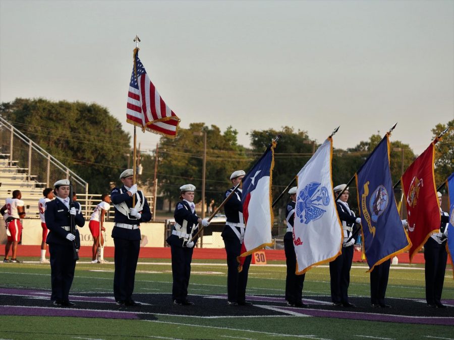 STARS AND STRIPES. Members of AFJROTC present the flag before the game. The organization participates in the pregame activities and posts the flags near the field house. 