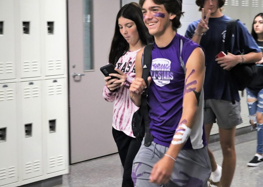 PAINTED UP.  Covered junior Hunter Seay shows off his Wildkat pride walking the halls in between classes. Students dressed in purple in support of the Wildkats and in support of the National Suicide Prevention Week.