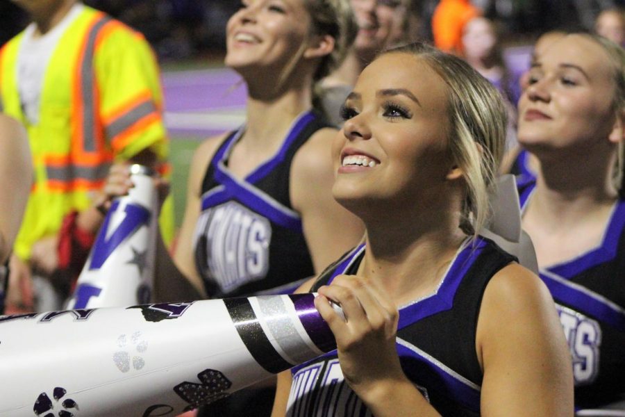 WE SAY WILLIS. Waiting for the student section to echo her cheers, senior cheer captain Mady Feist leads the cheerleaders at the game against Houston Bellaire. 