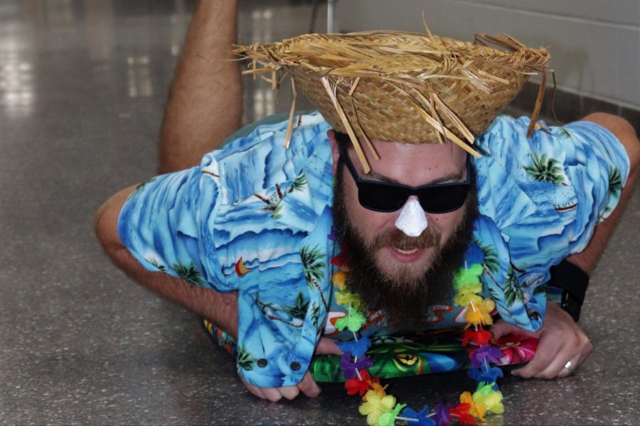 SURFS UP. Boogie boarding down the hall, English teacher Chris Slovak shows his tropical side for Hawaiian Day. 