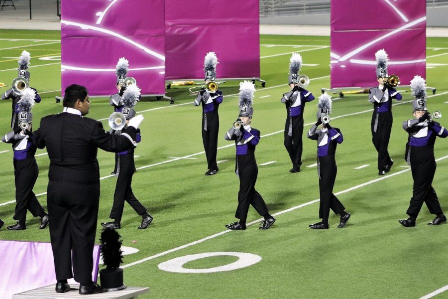 LEADING THE PACK.  Drum major junior Tony Silverio leads the band during district UIL competition. 