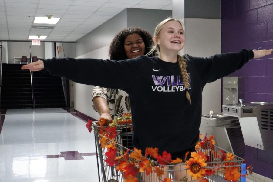 IM ON TOP OF THE WORLD. Using her basket to carry sophomore Grace Wilder to class, senior Avari Ford takes advantage of her anything but a pack pack prop. 
