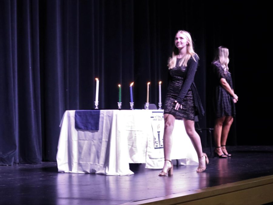 RECOGNIZED. Walking across the stage, junior Shaela Wylie is inducted into NHS on Tuesday in the PAC. 