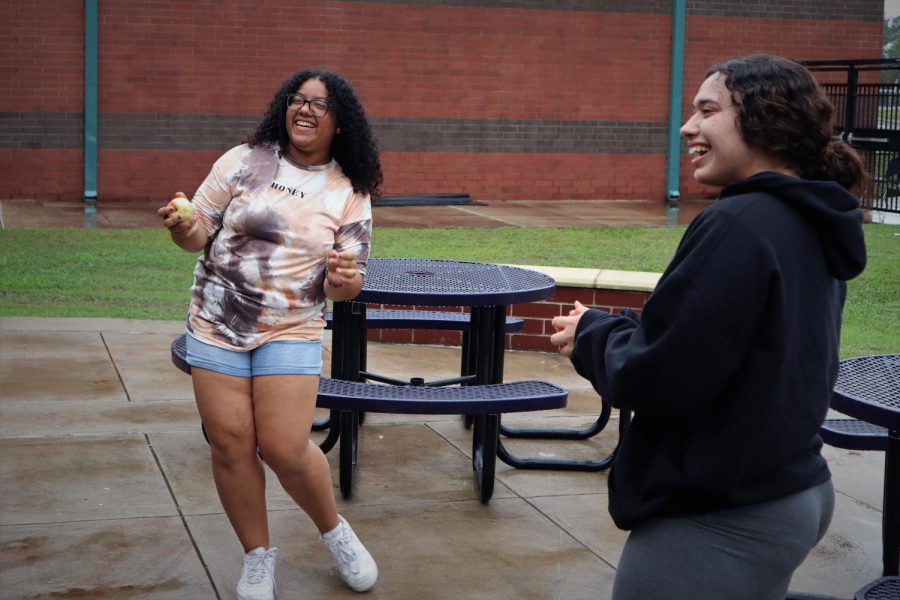 DANCE IN THE RAIN. A small shower during lunch was the perfect time for junior Yabi Paulino and senior Janice Maldonado to play in the rain. 
