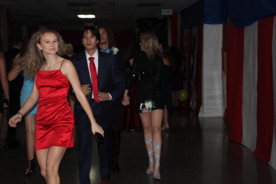 CIRCUS FUN. With the halls transformed, junior Sophia Runey and her date Caden Hon enter the dance. 