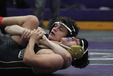 CRADLE TO PIN. in a match last season against Foster, senior Nick Boies works to defeat his competitor. The team recently supported Boies during a tough time for his family. 