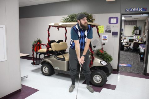 HO! HO! HO! HOLE IN ONE. Using the hall as a putting green, English teacher Chris Slovak gets in the school spirit with his gold attire and gold cart. 