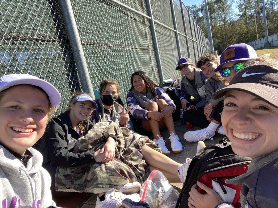 LET SPRING BEGIN. Varsity tennis players wait for their next match of the day. The team has been preparing for month to be ready for the competition they will face. 