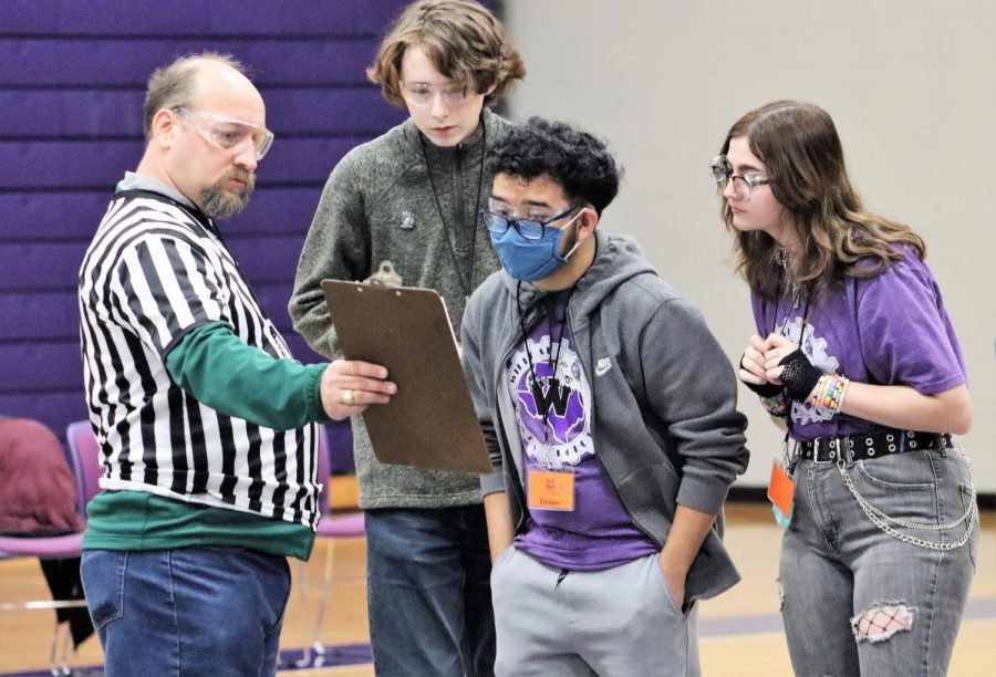 Looking at the referees notes after match two, sophomore Owen Baker, junior Javier Banda and sophomore Hannah East compete at the FIRST Robotics meet on Saturday, January 15, 2022. The Wildkat Robotiks team hosted the meet for the Greater Houston North League.  photo by Heather Jackson