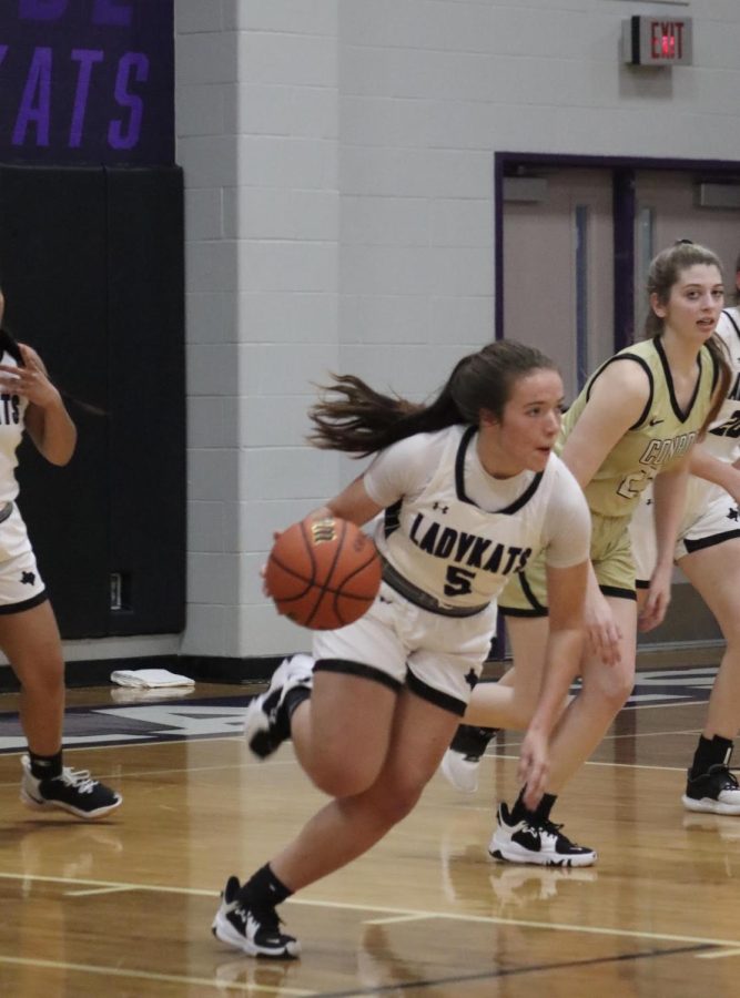 RUNNING FAST. After getting the rebound, junior Lucy Smith runs the ball to the other side of the court during the Conroe game.