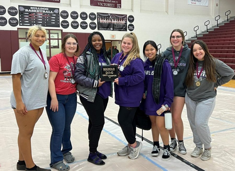 CHAMPIONSHIP TEAM. The girls team took first at the Magnolia meet on Feb. 10. Members of the girls and boys teams are working to complete at regionals. 