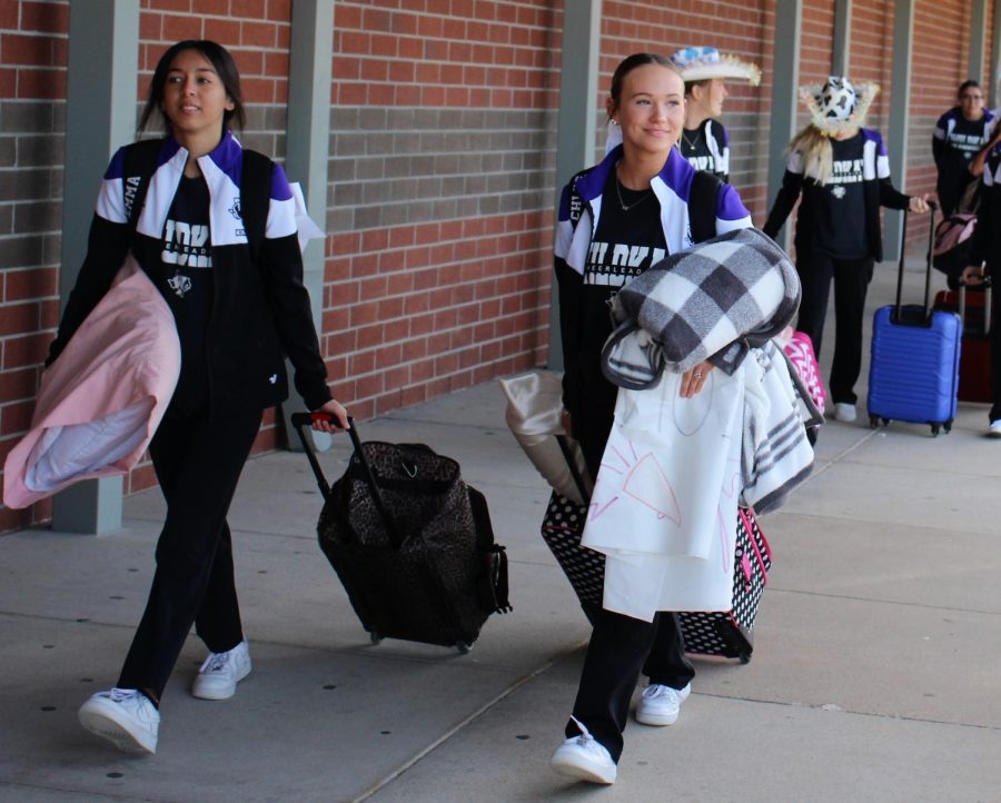 ON THE WAY TO STATE. On their way to bus to Ft. Worth, juniors Emma Akinson and Chloe Henderson walk along the bus ramp. 