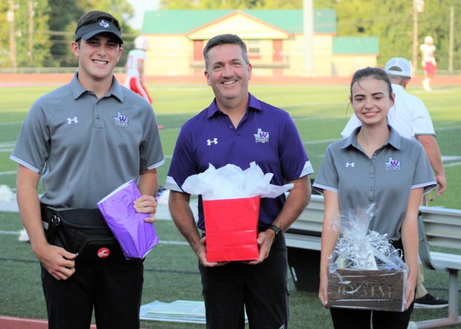 FAVORITE NIGHT. Seniors Cole Arnold and Allie Benson recognize head trainer Scott McClatchy as their favorite teacher. Each year members of the training staff pick their favorite teacher along with the football team, cheerleaders and Sweethearts. 