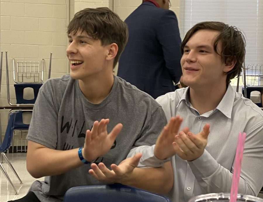 REGIONALS BOUND. Reacting to the good news, juniors Michael Schlowinski and Logan Hoover applaud for the 4th place winner in informative speaking. After not placing in the bottom three, Schlowinski realizes he is regional bound. 