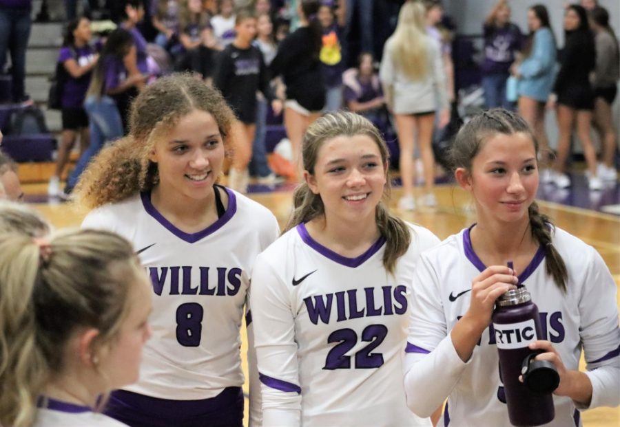 VOLLEYBALL VICTORY. During a time out against New Caney, junior Christa Johnson, freshman Tori Greeney and senior Taylor Harris huddle with the team. The Wildkats beat New Caney 25-15, 25-23, 25-17. The team is now 1-0 in district play. Photo by Reid Henderson.