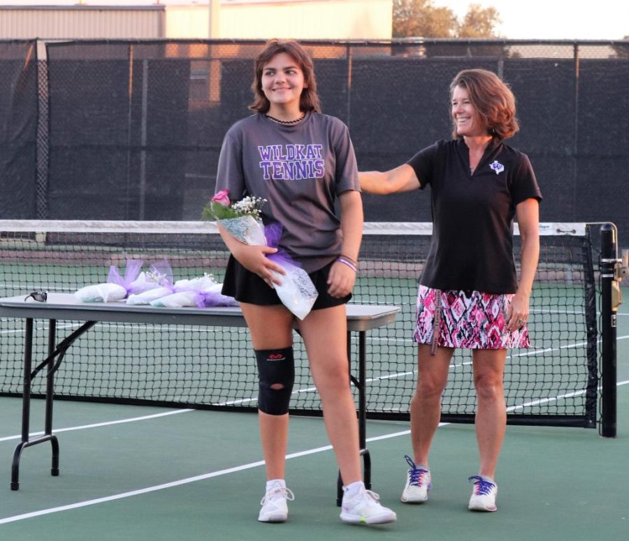 ALL SMILES. After being recognized, senior Emma Baron is congratulated by Coach Lisa Parrott on senior night. 