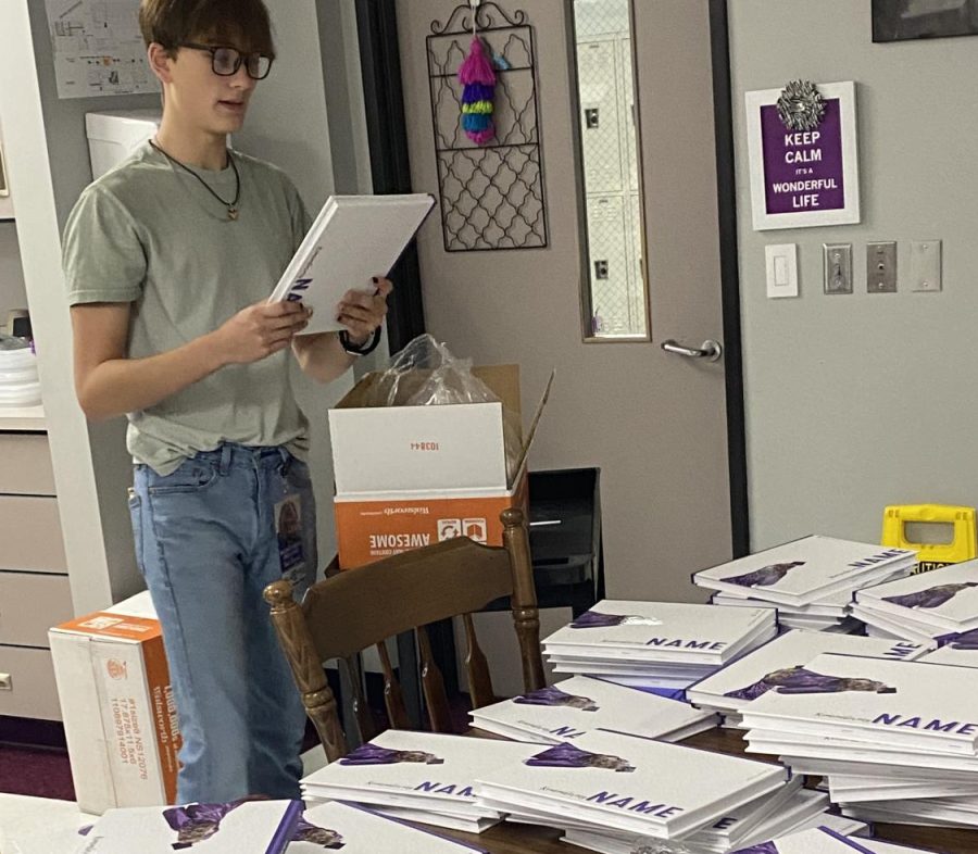 NAME AFTER NAME. Sorting the books with personalization, junior Stone Chapman begins the process of getting books ready to deliver. 